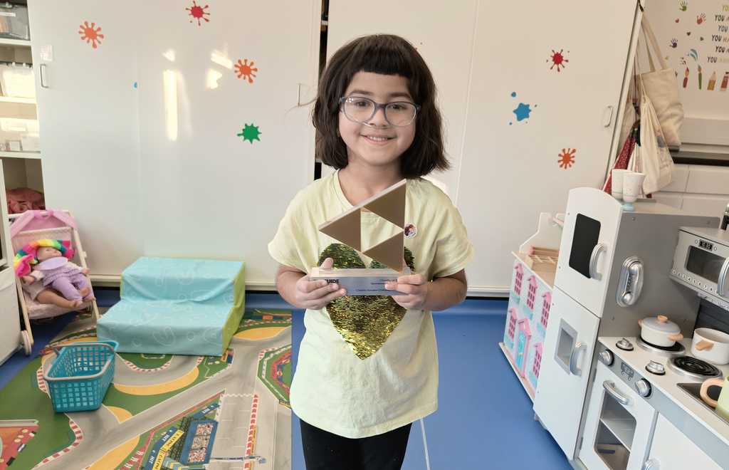 Photo of child with trophy