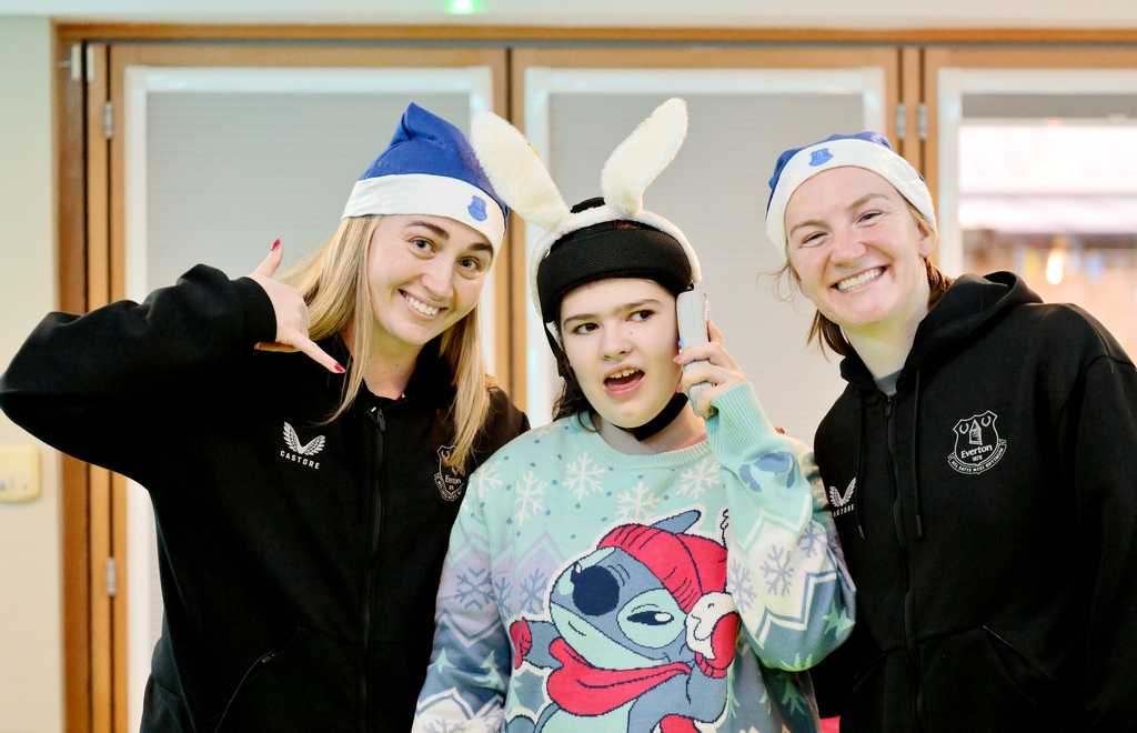 Two Everton Women Footballers with a Claire House Child