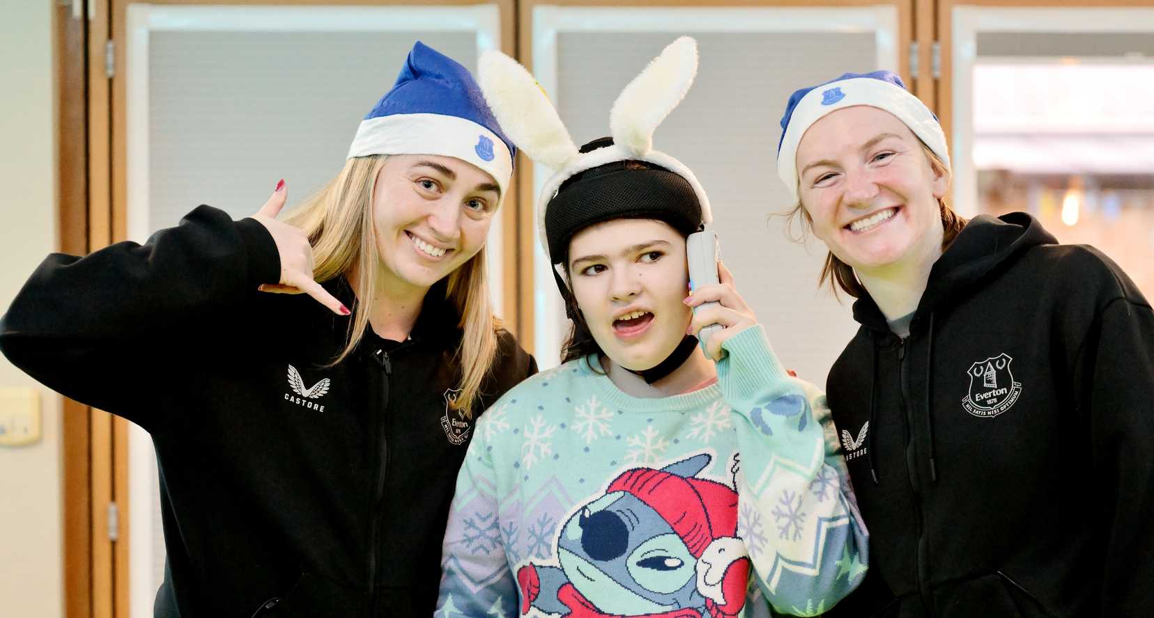 Two Everton Women Footballers with a Claire House Child