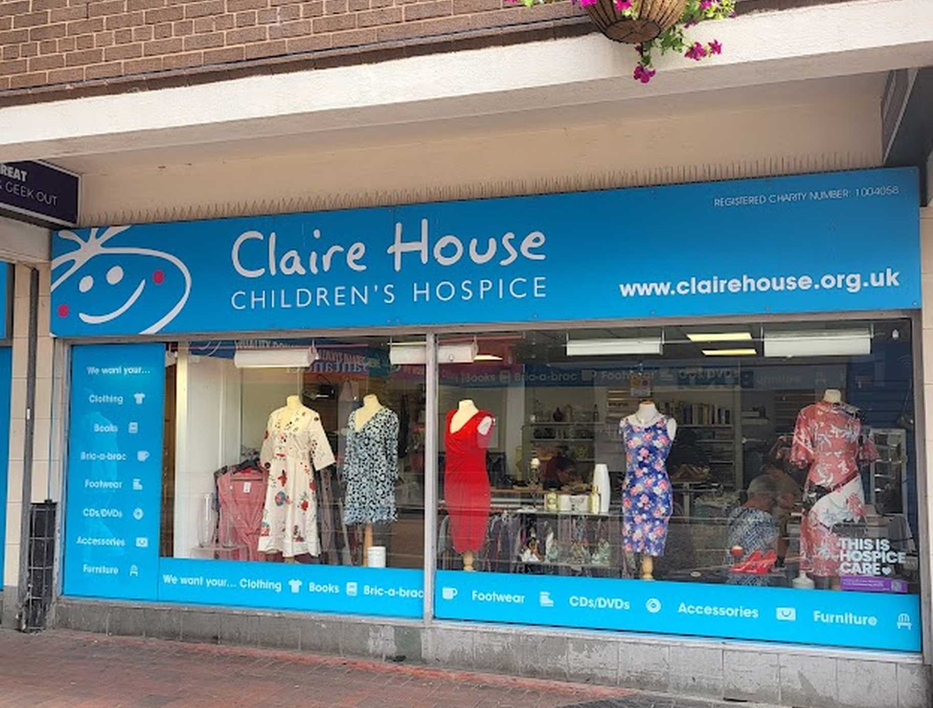 Photo of St Helens shop front with clothes in the window