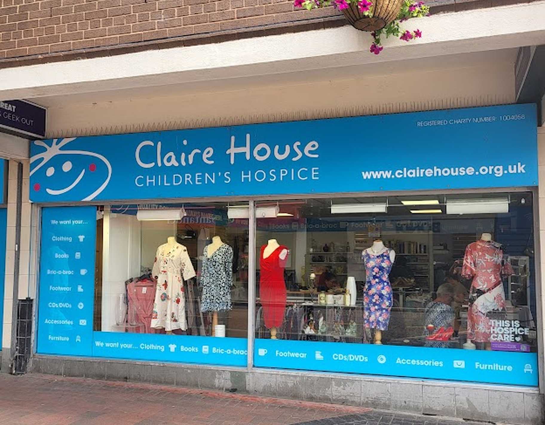 Photo of St Helens shop front with clothes in the window