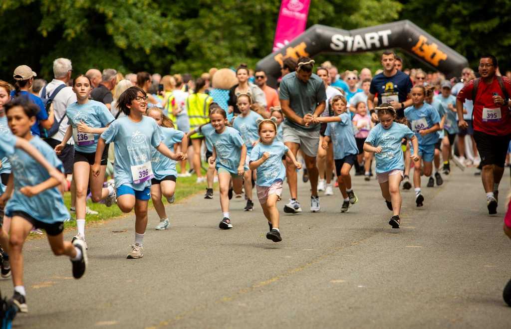 Participants in the Claire House Bear 3K run from the start line during the family-friendly charity event in Birkenhead Park.